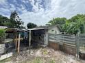 Backyard featuring a unique mural on the back of the home, banana trees and a covered structure at 269 12Th Ave, Ocoee, FL 34761