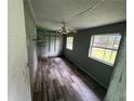 Bedroom with natural light from two windows, featuring wood-look flooring and a ceiling fan at 269 12Th Ave, Ocoee, FL 34761