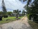 Lush front yard with a mature palm tree and a long driveway leading to this cozy home at 269 12Th Ave, Ocoee, FL 34761