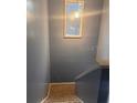 Interior shot of a carpeted staircase with light gray walls and a decorative mirror at 5084 Downing St # 2, Orlando, FL 32839