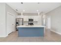 Modern kitchen with stainless steel appliances and central island at 109 Violet Ct, Kissimmee, FL 34759