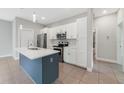 Well-equipped kitchen featuring stainless steel appliances and blue island at 109 Violet Ct, Kissimmee, FL 34759