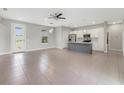 Spacious open-concept living area with modern ceiling fan and lots of natural light at 109 Violet Ct, Kissimmee, FL 34759