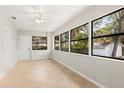 Bright bedroom with tile flooring, a ceiling fan, and natural light through large windows at 575 Lake Mccoy Dr, Apopka, FL 32712