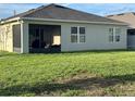A screened-in lanai and generous yard provide ample outdoor living space at 577 Talisi Loop, St Cloud, FL 34771