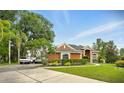 Beautiful single-story home boasting a circular driveway and well-maintained landscaping at 6839 Hidden Glade Pl, Sanford, FL 32771