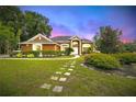 Charming single-Gathering home featuring a lush garden, manicured lawn, and inviting curb appeal at 6839 Hidden Glade Pl, Sanford, FL 32771