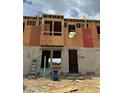 Image shows a townhome in progress, highlighting the block foundation and the start of the wooden framing at 15058 Grove Lake Dr, Winter Garden, FL 34787