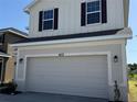 A well-maintained home exterior with a two-car garage and neutral color palette at 4113 Sagefield Dr, Harmony, FL 34773