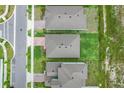 Aerial view of homes showcasing their roofs, driveways, and manicured lawns in a neat neighborhood layout at 5724 Camilla St, St Cloud, FL 34771