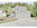 Two-story home featuring an attached two-car garage, neutral paint and meticulously maintained lawn at 2262 Stonehedge Loop, Kissimmee, FL 34743