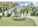 Charming home features a two-car garage, mature landscaping, and a well-manicured lawn at 2262 Stonehedge Loop, Kissimmee, FL 34743