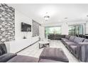 Spacious living room with modern decor, stylish furniture, and an abundance of natural light at 2613 Calistoga Ave, Kissimmee, FL 34741