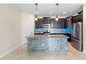 Modern kitchen with stainless steel appliances, tiled backsplash, and center island at 2008 Curia Rd, Winter Garden, FL 34787