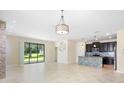 Open-concept living room with sliding glass doors and stylish light fixture at 2008 Curia Rd, Winter Garden, FL 34787