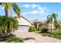 Charming single-story home with paver driveway, mature landscaping, and a two-car garage at 3643 Weatherfield Dr, Kissimmee, FL 34746