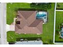 Aerial view of the home featuring a screened pool and landscaped yard in a residential neighborhood at 344 Barbera Dr, Davenport, FL 33897