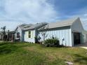 Side view of the house shows the two car garage and nice yard at 311 Pop Top Ln, Daytona Beach, FL 32124