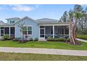 Charming single-Gathering home featuring a spacious, screened-in front porch and well-manicured landscaping at 311 Pop Top Ln, Daytona Beach, FL 32124