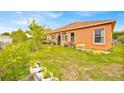 A verdant backyard with lush grass and thriving greenery, offers tranquility and privacy at 675 Elbridge Dr, Kissimmee, FL 34758