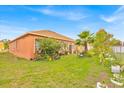 Spacious backyard with lush greenery and vibrant flowers, perfect for outdoor activities at 675 Elbridge Dr, Kissimmee, FL 34758
