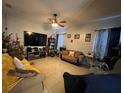 Spacious living room featuring tile floors, ceiling fan, and comfortable seating at 675 Elbridge Dr, Kissimmee, FL 34758