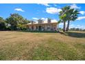 Charming home with a metal roof, dormers, and a wide front porch, surrounded by a green lawn and mature trees at 2198 W Highway 329, Citra, FL 32113