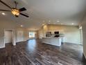 Open-concept living space featuring sleek flooring, a modern kitchen island, and ample natural light at 6711 Sw 64Th Ave, Ocala, FL 34476