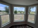 Bright room featuring three large windows offering scenic outdoor views and natural light at 6711 Sw 64Th Ave, Ocala, FL 34476