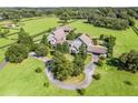 Aerial view of a sprawling estate on lush grounds with equestrian facilities at 10621 Sw 11Th Ter, Ocala, FL 34476