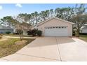 This home features an attached two-car garage and a spacious driveway for ample parking at 8447 Se 137Th Loop, Summerfield, FL 34491