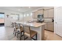 Kitchen island with a granite countertop, stainless steel appliances and seating for four people at 4336 Nw 55Th Ct, Ocala, FL 34482