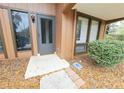 Front entrance of condo with gray door and small porch at 19728 Sw 83Rd Place Rd # A-1, Dunnellon, FL 34432