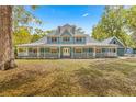 A large two story home with a wrap around porch at 7629 Sw 188 Ave, Dunnellon, FL 34432