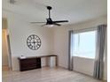 Bedroom featuring laminate floors, a ceiling fan, and a large window at 9951 Sw 62Nd Ter, Ocala, FL 34476