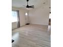 Living room featuring hardwood floors, front door, and large windows at 9951 Sw 62Nd Ter, Ocala, FL 34476