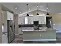 Modern kitchen with white cabinets, granite island, and stainless steel appliances at Tbd W C 466 # Lot 1, Oxford, FL 34484