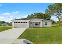 Newly constructed one-story home with a two-car garage and a well-manicured lawn at 16588 Sw 25Th Terrace Rd, Ocala, FL 34473