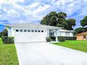 Inviting home featuring a freshly-painted exterior, manicured lawn, and a spacious two-car garage at 9866 Sw 59Th Cir, Ocala, FL 34476