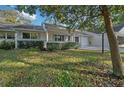 Inviting single-story home featuring a cozy front porch with white columns and trimmed landscaping at 8655 Sw 98Th Street Rd # G, Ocala, FL 34481
