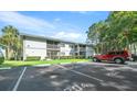 Parking lot with building and green space in background at 567 Midway Trak # H102, Ocala, FL 34472
