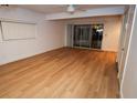 Bright living room featuring wood-look floors and sliding glass doors at 11001 Se Sunset Harbor Rd # A08, Summerfield, FL 34491