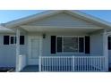 A charming porch featuring a white picket fence that welcomes you home at 10926 Sw 78Th Ct, Ocala, FL 34476