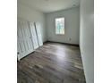 Spacious bedroom with wood-look flooring and ample closet space at 5394 Nw 6Th Pl, Ocala, FL 34482