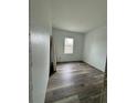 Well-lit bedroom with wood-look floors and a window at 5394 Nw 6Th Pl, Ocala, FL 34482