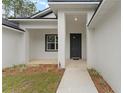 Inviting front porch with decorative plants and a walkway at 4444 Sw 118 Ter, Ocala, FL 34481