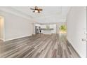 Open-concept living room with hardwood floors and a ceiling fan at 4444 Sw 118 Ter, Ocala, FL 34481