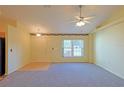 Bright living room with vaulted ceiling, carpet, and view to kitchen at 352 Marion Oaks Ln, Ocala, FL 34473