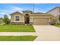 Charming single-Gathering home with a well-manicured lawn, a two-car garage, and stone accents at 8996 Sw 49Th Cir, Ocala, FL 34476