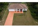 Aerial view of property with a long driveway and a well-maintained lawn at 15747 Sw 47Th Avenue Rd, Ocala, FL 34473